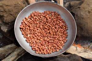 Roasting groundnuts, another protein source.