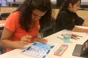 Xiomara,12, participating in illustration workshop