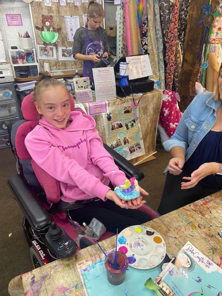 Emily enjoying pottery painting with Michelle