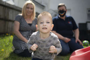 James with mum Danielle and Ema in the background