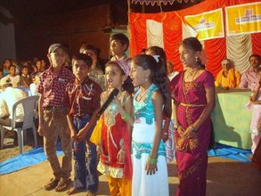 Children doing a group song on their Annual Day