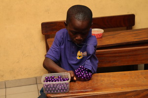 MIND kid working on his beading project
