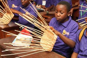 MIND kid working on her basket weaving project