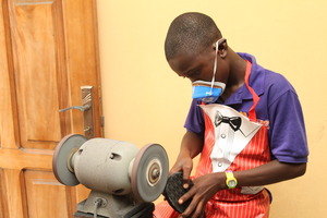 MIND kid working on his shoe making project