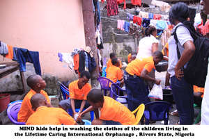 Helping to wash the clothes in the orphanage