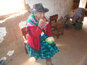A woman eats lunch with vegetables from the garden
