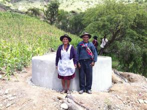 Older farmers with one of water tanks built