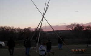 Camp participants learning to raise tipi