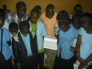 Students watching demonstration on rice processing