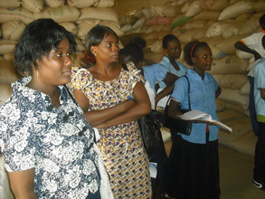 Standing by bags of rice (finished products)
