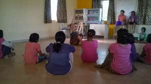 Girls learning dance from an Volunteer