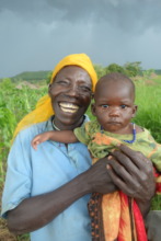 Beneficiary and her grandson on their peanut farm.