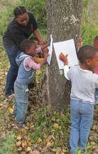 Nomakhaya shows little ones to do bark rubbing