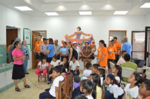Volunteers and children during reading activity