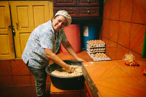 A mother volunteers to cook school lunches