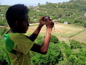 A student takes photos during enrichment class