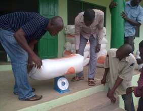 Trainees weigh sawdust for composting