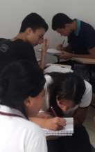 STUDENTS CONCENTRATE ON AN EXERCISE