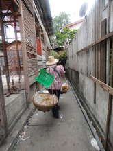 a woman selling items in the slum village