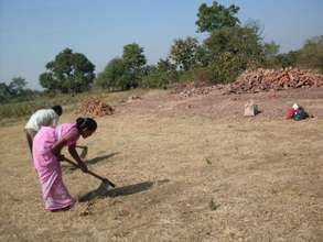 With packed lunch nearby, Geeta preparing the site