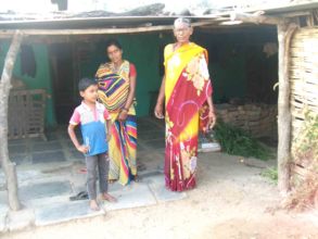 Triveni in front of her home with family.