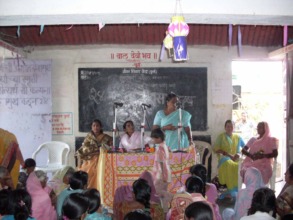 Mangala in centre presiding at a village function