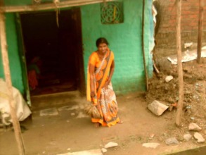 Kamal sweeping the courtyard of her house