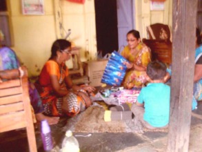 Packing incense sticks for sale with her friends