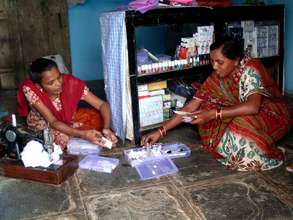 Vandana, sewing clothes & attending a customer