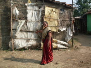 Surekha showing a wall of her house to be repaired