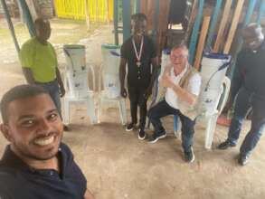 Luis and helpers show off their water filter sytem