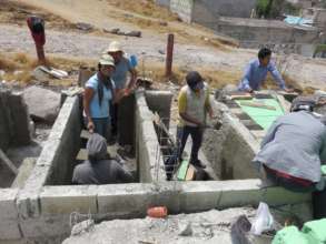 Families helping build the new school latrine
