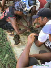 Mixing manure and clay for the seed balls