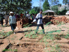 Zahana's teacher showing the new moringa trees