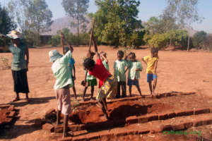 Digging the holes to plant Moringa seedlings