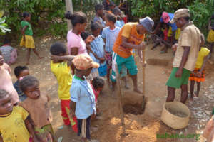 Digging the hole for the tree eyed by many