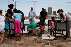 Melanie and volunteers working with kids