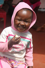 Happy child snacking on a banana