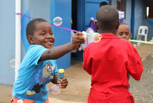 Children celebrating before the ribbon cutting