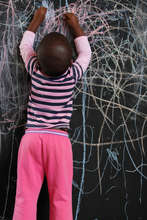 A student enjoying our new chalkboard walls