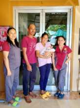 A loving midwife discharging a new family