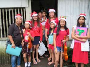 Mercy In Action midwife team and family caroling