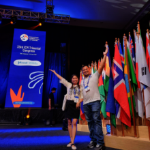 Nerissa and Alex with flags of nations at ICM