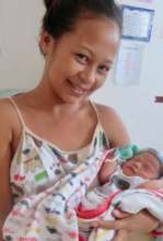 Joyful new mother and baby in birth center