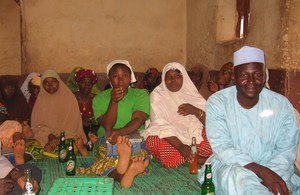 Community dialogue attended by men and women