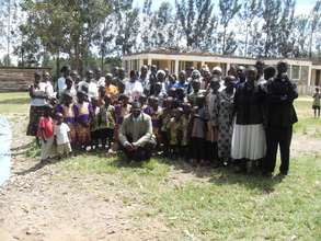 women present clothes to orphans