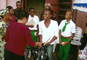 president presenting food to an orphan