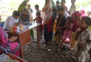 Women getting treatment in mobile clinic