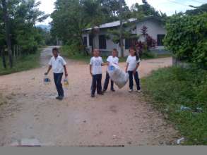 Students collecting recyclables around a town
