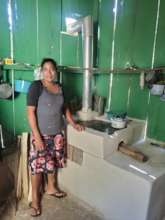 Woman with her new fuel-efficient stove